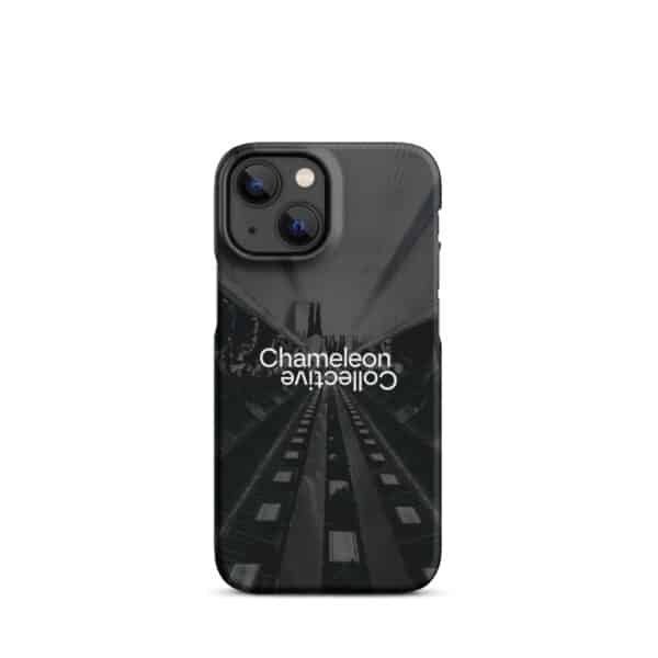 A smartphone with a sleek black Snap case for iPhone® displaying the words "Chameleon Collective." The design art features a dark urban scene with symmetrical lines, possibly depicting an underground passage with lights along the sides. The phone has dual cameras.